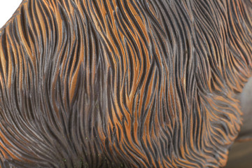 The bronze texture with lines on it.