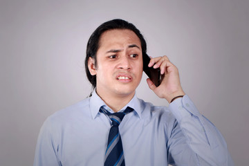 Young Man Talking on Phone, Shocked Worried Expression