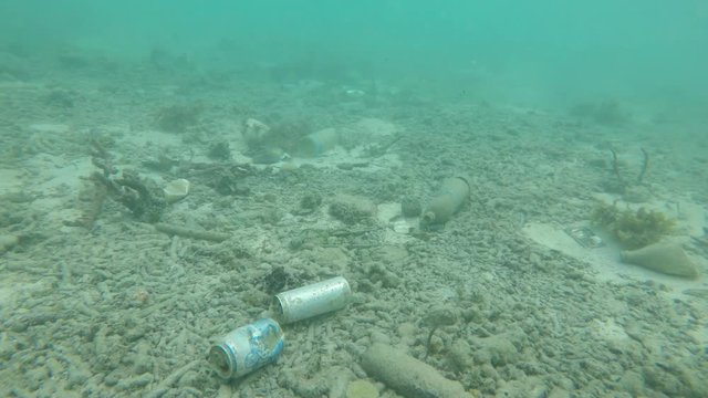 Pollution in ocean. Drinks cans, plastic bottles and bags dumped in sea accumulate on ocean floor. 