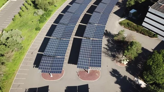 Drone over solar large solar panels next to building