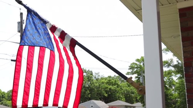 American flag hanging from the front of house