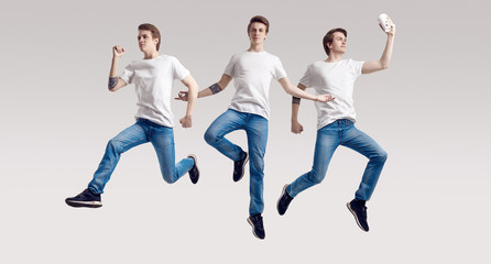 Fototapeta na wymiar Multiple portrait of a jumping handsome hipster man