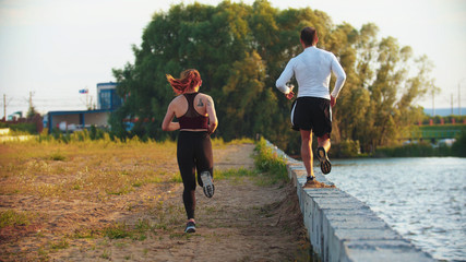 Man and woman running on the waterfront