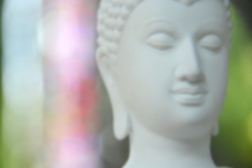 Blurred image of the white stone Buddha face