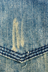 clothing items blue stonewashed faded jeans cotton fabric texture with seams, clasps, buttons and...