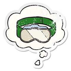 cartoon goggles and thought bubble as a distressed worn sticker