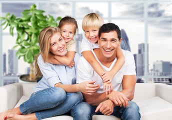 Young  family at home smiling at camera