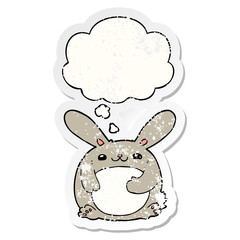 cartoon rabbit and thought bubble as a distressed worn sticker