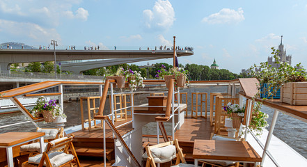 The interior of the urban river ship, with a panoramic view of the urban landscape. The concept of tourism, recreation, walking around the city, rest in the city. River transport.