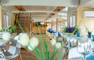The interior of the urban river ship, with a panoramic view of the urban landscape. The concept of tourism, recreation, walking around the city, rest in the city. River transport.