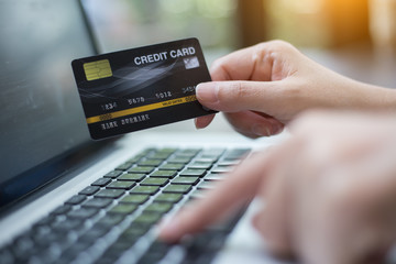 Hand holding credit card with shopping online. Online payment concept.