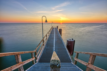 Sunrise at a pier on the german Baltic Sea coast