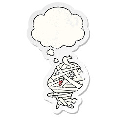 cartoon halloween mummy and thought bubble as a distressed worn sticker