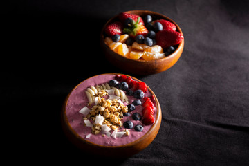 Fototapeta na wymiar Smoothie bowl with fruits in wooden bowl