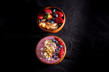 Smoothie bowl with fruits in wooden bowl