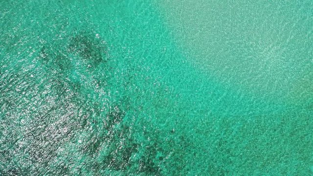 Looking down on the turquoise water in the sea of Jamaica. Soft waves and slight reflection