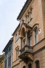 Fototapeta na wymiar Fragment of the building with a decorative balcony on the Cetatii street. Sibiu city in Romania