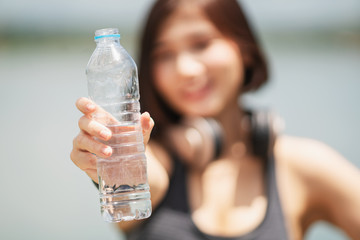 young woman show bottle of water