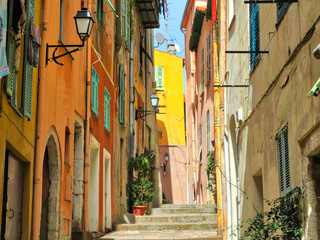 Fototapeta na wymiar Scenic Villefranche streets in historic city center close to the sea promenade