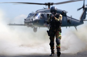 Special force assault in a mission with in helicopter background