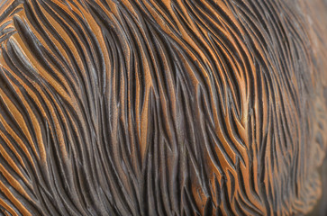 The bronze texture with lines on it.