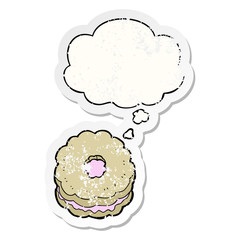 cartoon biscuit and thought bubble as a distressed worn sticker