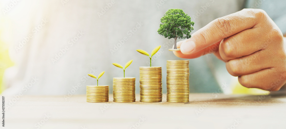 Poster businessman putting money stack with tree growing on table concept saving finance and accounting