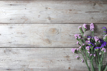 Pink flowers on table wooden background.Copy space for text on wood texture