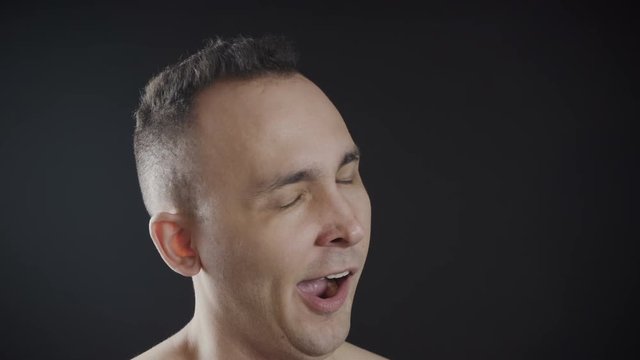 Footage of the adult yawning man