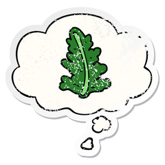 cartoon leaf and thought bubble as a distressed worn sticker