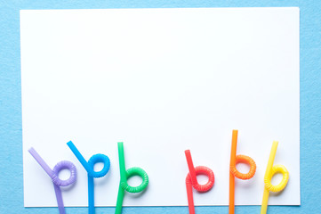 Rainbow color straws with white copy-space for text