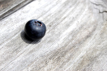 Single Blueberry On A Wooden Table