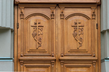 wooden door in Church-close with the crucifixes