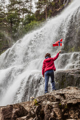 Obraz premium Tourist woman at waterfall Svandalsfossen, Norway