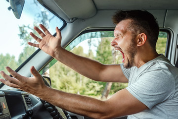 Aggressive Man, the driver of the car is outraged at the wheel during the trip. Emergency,...