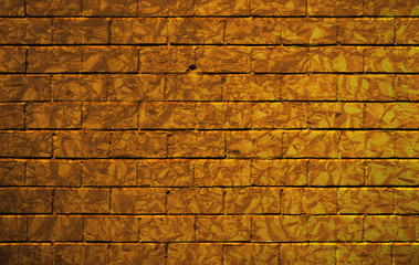 Brick wall with golden camouflage pattern