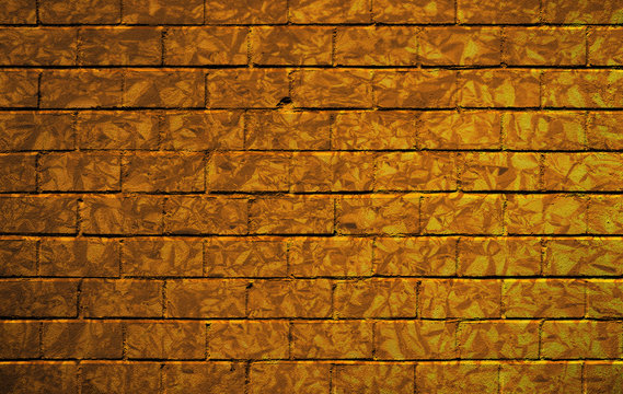 Brick wall with golden camouflage pattern