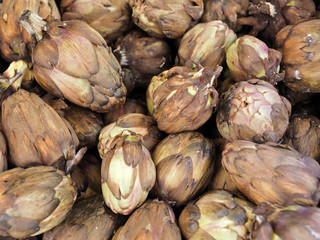 Pile of fresh artichokes at a food market