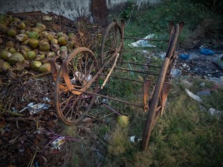 dumped garbage, coconut shells, broken vehicles and wheels