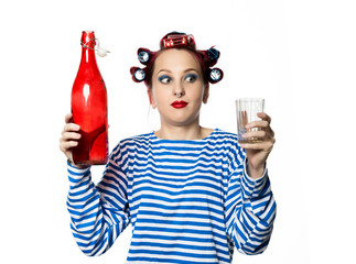 strange housewife holding an empty bottle of wine and glass on a white background. Concept female alcohol addiction