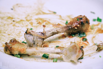 Chicken Bones scraps on white plate
