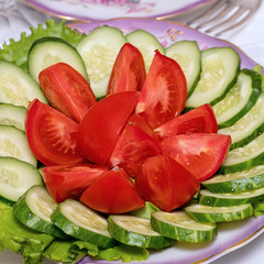 Sliced cucumbers and tomatoes in plate