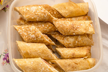 Stuffed pancakes in a food container