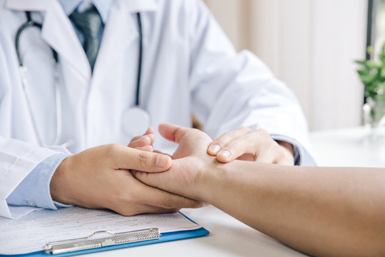 Extreme close-up of a doctor examining patient's hand in the medical office - Powered by Adobe