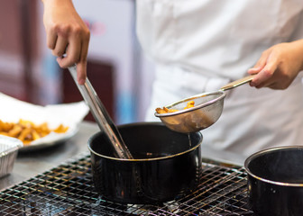 Chef is cooking french fries in the kitchen, Chef cooking fried potato in pan