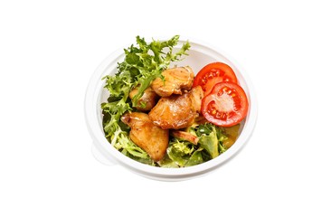 Fototapeta na wymiar Isolated cooked dish with chicken and greens and tomatoes in white plastic container.