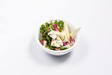 Healthy Salad of radishes, feta cheese, arugula and pears in a white bowl on white background. Healthy lifestyle concept isolated