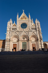 Facade of the Siena Cathedral, Santa Maria Assunta 1220-1370 with clear blue sky. Tuscany, Italy, Europe