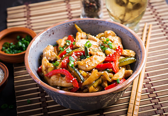 Stir fry chicken, zucchini, sweet peppers and green onion. Asian cuisine