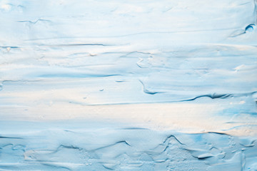 Blue and white acrylic paint. Sky and clouds effect abstract background. Colored mousse surface.